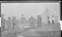 [Group of men dressed as indians at campsite]
