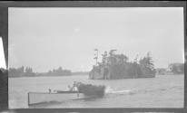 [People in motor boat on river]