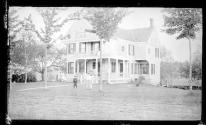 [Woman & child outside house]