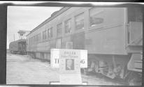 [Railroad cars with sign "Zollers Color Pictures"]