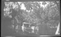 [People in boat on river]