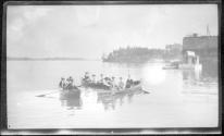 [People in rowboats on river]