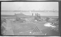 [People at cannon emplacement overlooking harbor]