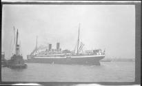 [Passenger ship & tug boat in harbor]