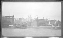 [View of ferry boat slips, city skyline distant]