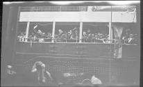 [People waving from deck of passenger ship]