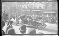 [Politician in open car in parade]