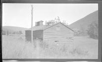 [Wooden building with wagon on roof]