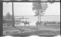 [Women on horseback, river in distance]