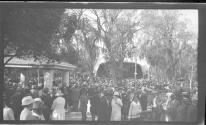 [Large group of people in park with band shell]