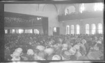 [Large group of people in auditorium]