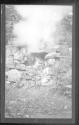 [Rocky landscape with campfire]