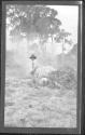 [Man clearing land]