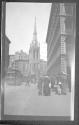 [Street scene, large church in distance]