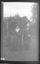 [Man & woman in costume in yard]