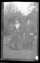 [Man & woman in costume in yard]