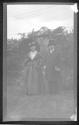 [Man & woman in costume in yard]