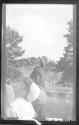 [Policeman & children in park, looking up into sky]