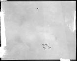 [Four airplanes in formation]