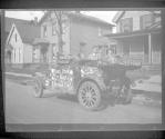 [Street scene, car with painted slogans]