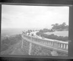 [Group of people in park, overlooking river]