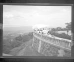 [Group of people in park, overlooking river]