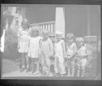 [Group of children by porch]