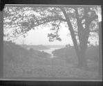 [Wooded landscape, bay in distance]