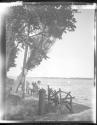 [Woman on bench by lake]
