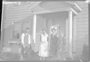 [Group of people on porch with dog]