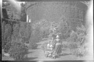 [Group of people in costume in gardens]