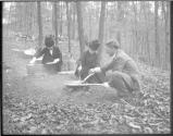 Two women and man having a cookout