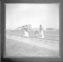 Mexican people crossing train tracks