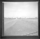 Field and houses along railroad