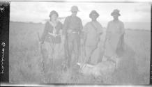 Osa Johnson, hunter and native guides posing with slain animal, African Safari