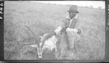Native posing with dead animal, African Safari