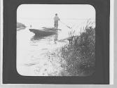 Man poling boat