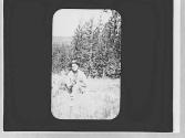 Charles Newhall on a log, Wyoming Trip