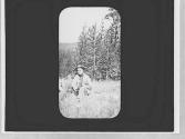 Charles Newhall on a log, Wyoming Trip