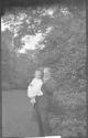 George Eastman holding Watson Newhall in garden