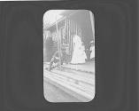 Guests sitting on porch, Oak Lodge Trip