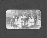 Group sitting around dining table, Oak Lodge Trip