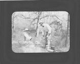 George Eastman and man tending campfire, Oak Lodge Trip