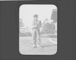 George Bonbright in yard looking at tools, Oak Lodge Trip