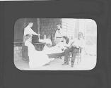George Eastman passing out refreshment on porch, Oak Lodge Trip