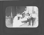 Guests relaxing on porch in rockers, Oak Lodge Trip