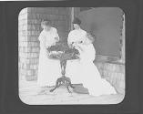 Women arranging greens on porch, Oak Lodge Trip