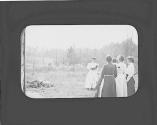 Woman photographing group of women, Oak Lodge Trip