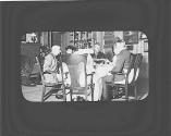 George Eastman and friends around dining table, Oak Lodge Trip