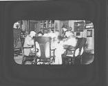 George Eastman and friends around dining table, Oak Lodge Trip